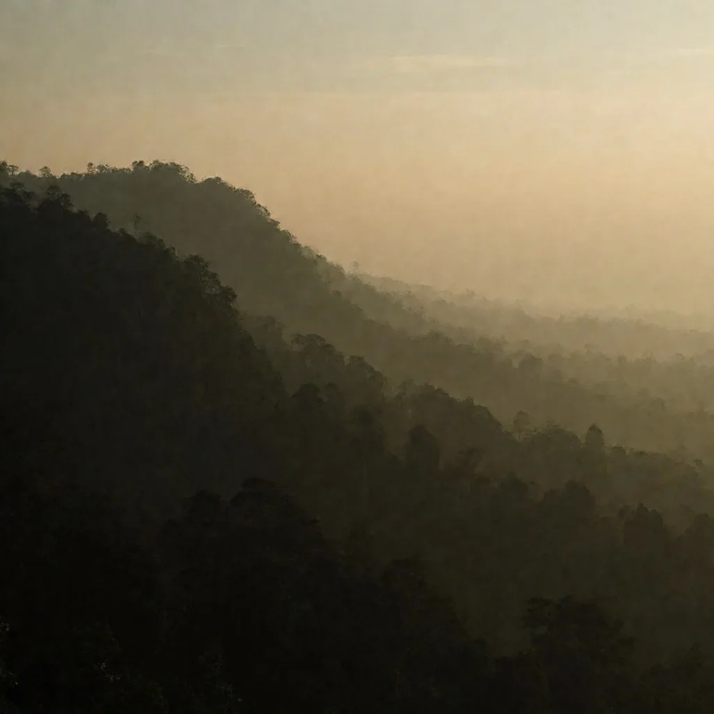 Misty mountain ridge at dusk over Yogyakarta highlands